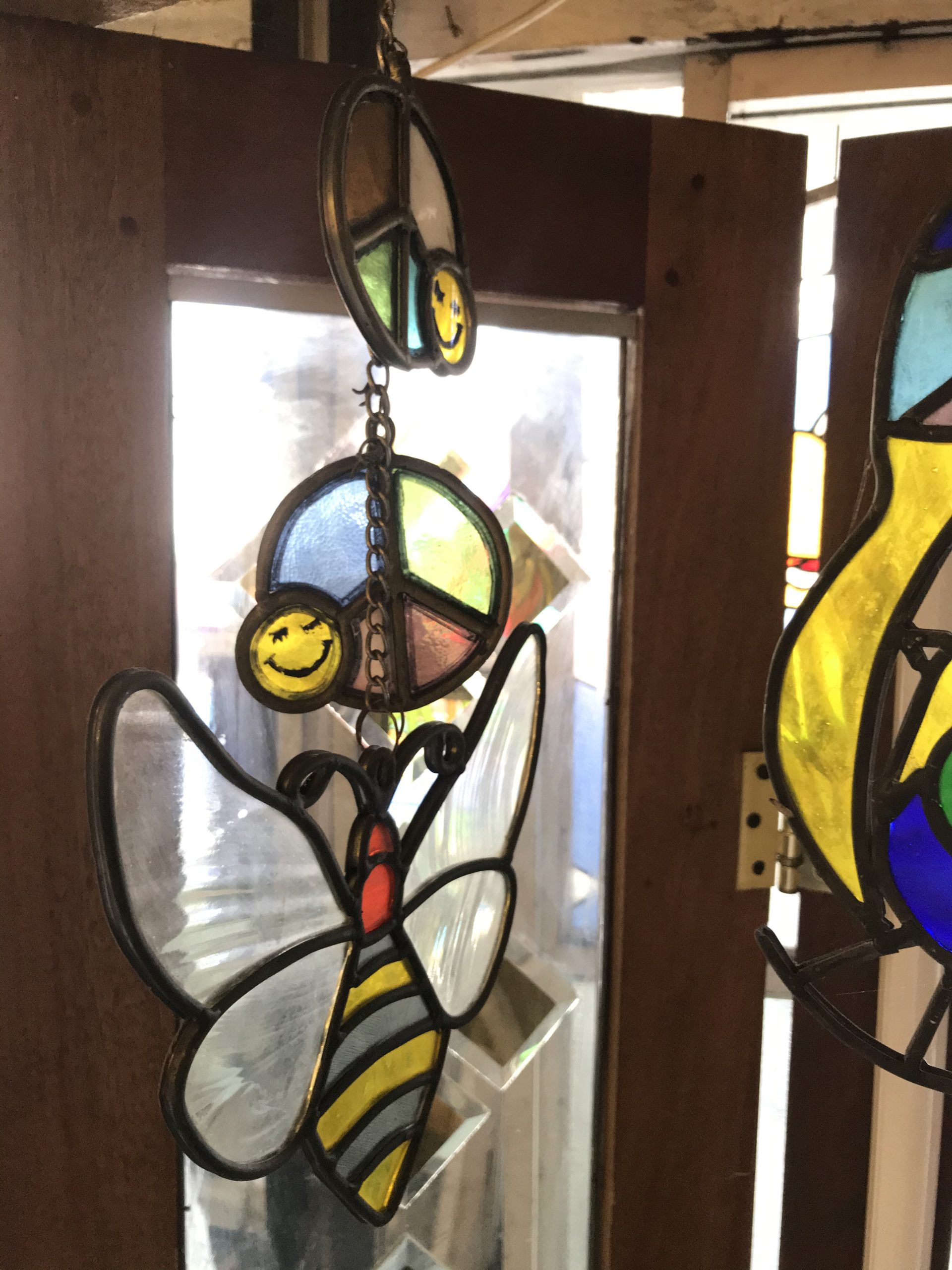 Stained glass Christmas ornaments being crafted in a Bali workshop