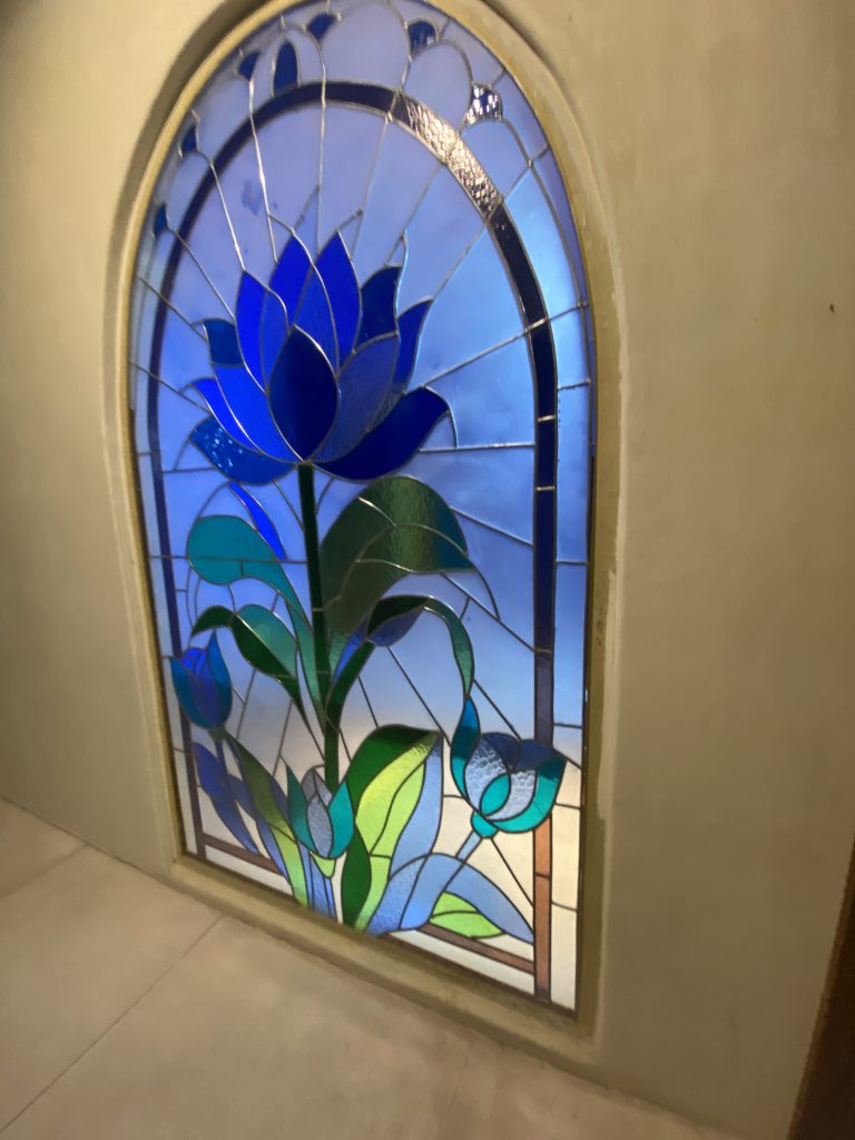 stained glass huge blue flower in merlins ubud bali.