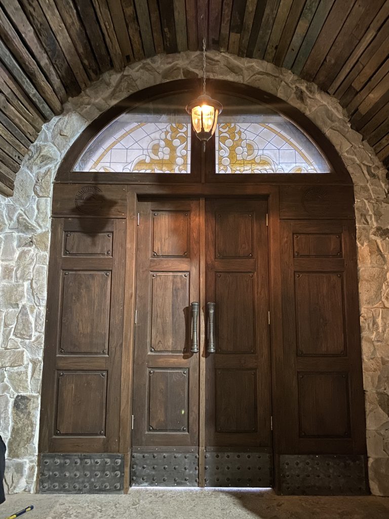 stained glass installation in a huge vintage wood door on nusa dua restaurant
