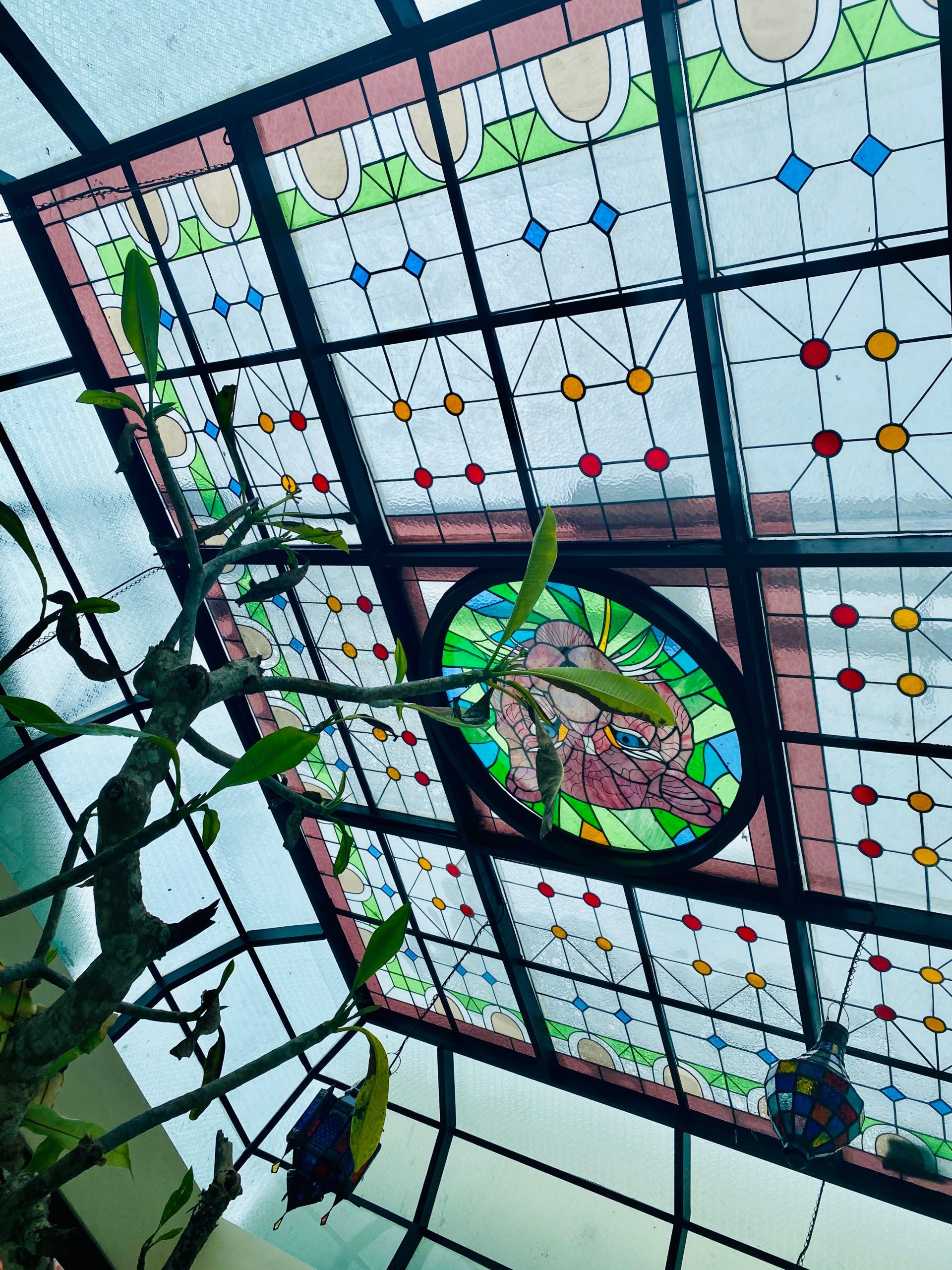 Stained glass perfectly integrated into a Balinese villa interior with matching color scheme and design elements