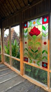 progress installation of a huge flower stained glass in ubud villa in bali