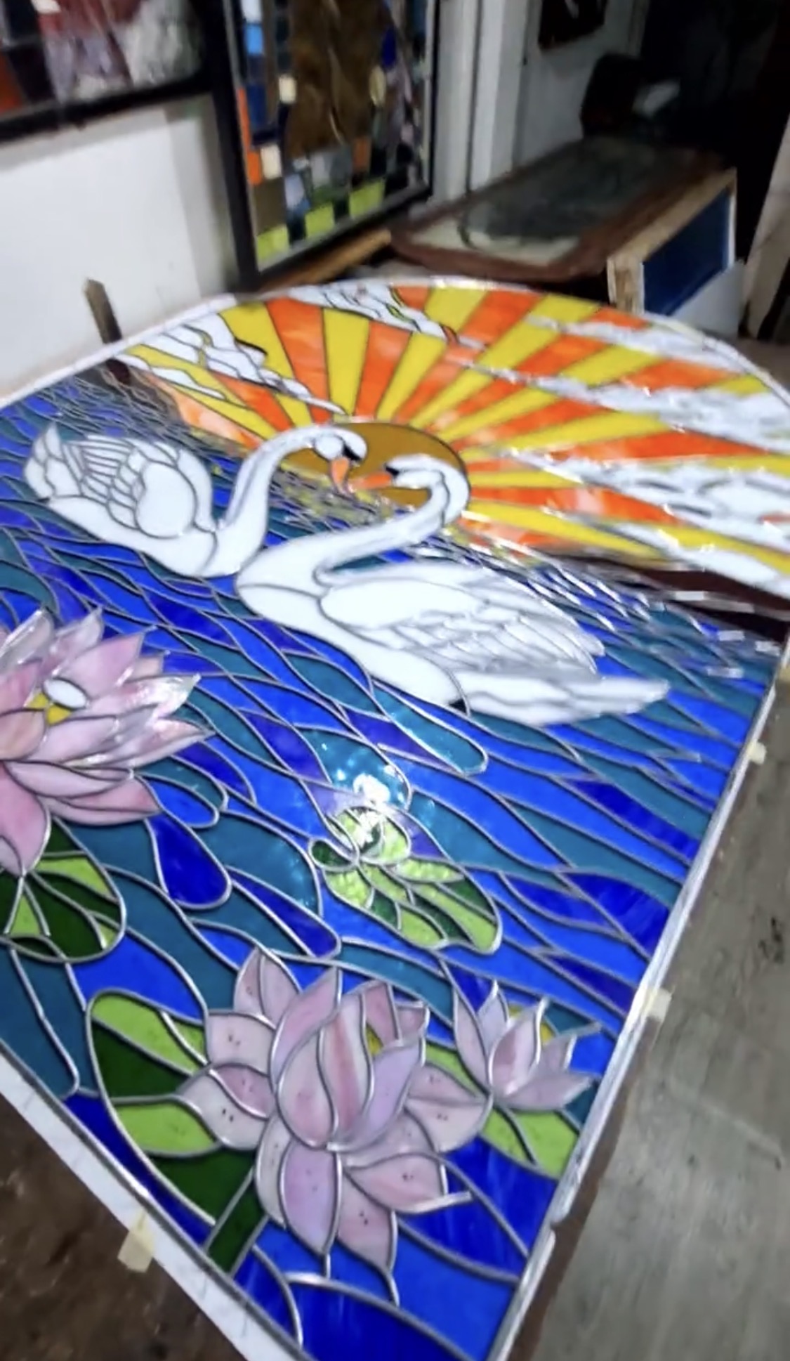 Swan and sunrise stained glass panel in lead came at the Era Glass Bali workshop in Sanur
